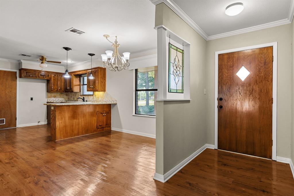 13539 Chapel Road Lorena, TX 76655 - Photo 6 of 37 Entryway with a wood-finish door featuring a diamond-shaped glass insert, accompanied by a stained-glass window panel