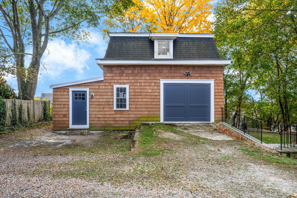 8 Pine Street, Unit 4 Boston, MA 02136 - Photo 2 of 12 a front view of a house with a yard and garage