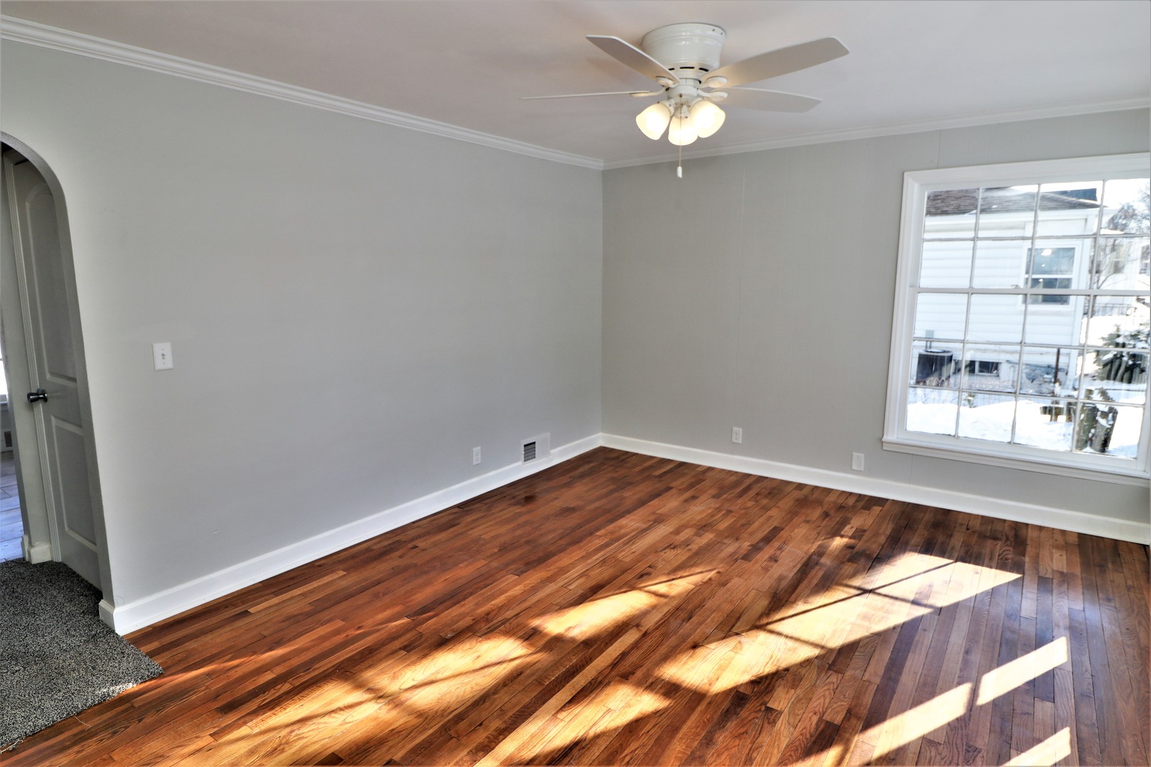 913 North Main Street Rochelle, IL 61068 - Photo 4 of 33 a view of an empty room with wooden floor and a window