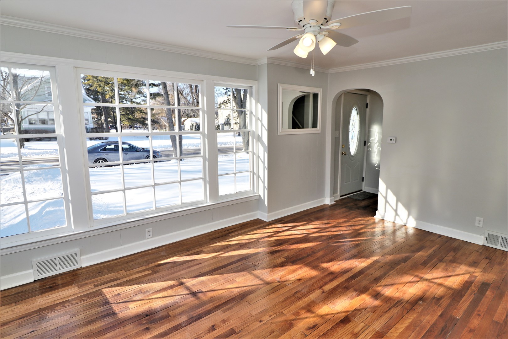 913 North Main Street Rochelle, IL 61068 - Photo 6 of 33 an empty room with wooden floor fan and windows