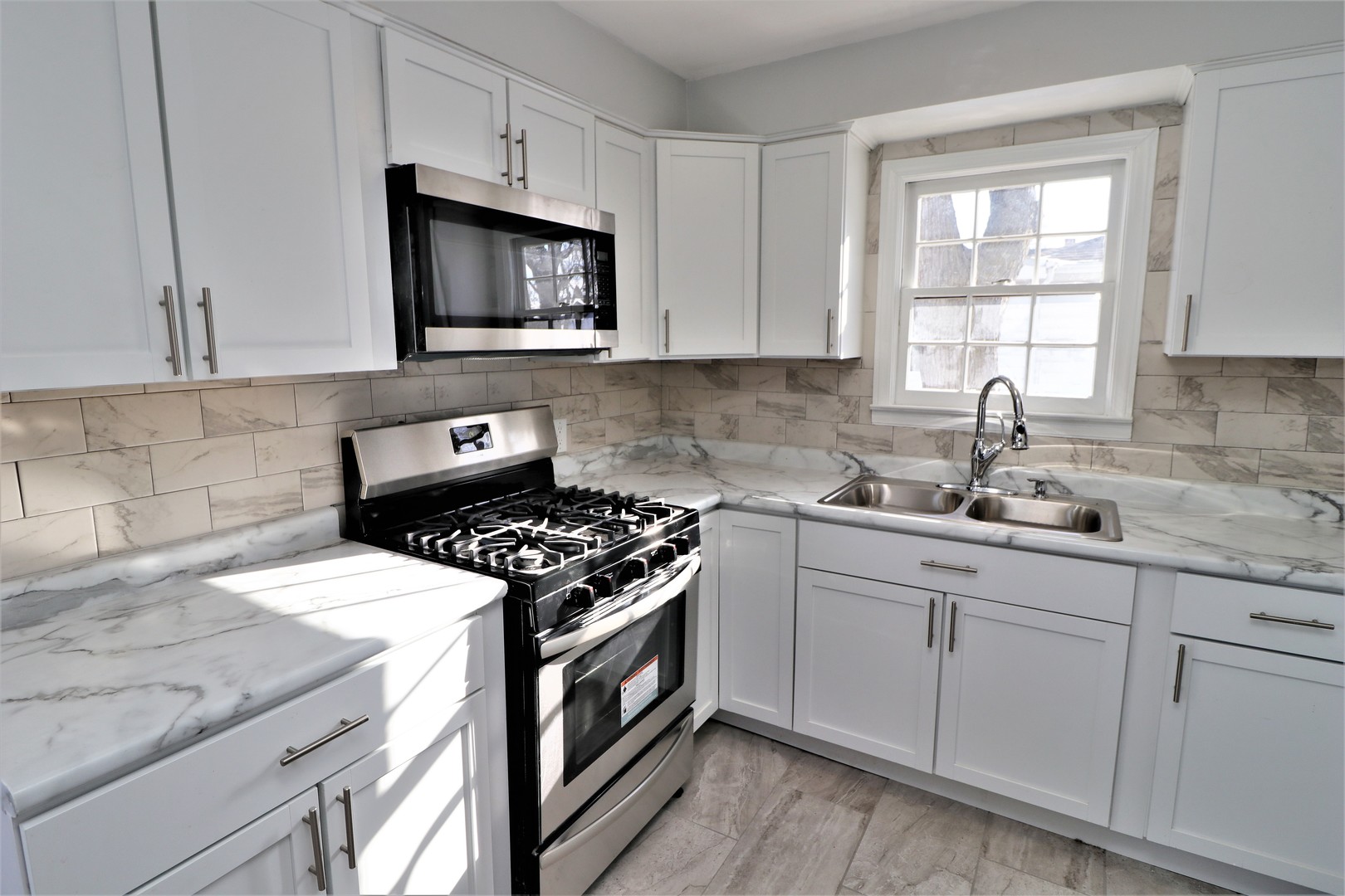 913 North Main Street Rochelle, IL 61068 - Photo 8 of 33 a kitchen with granite countertop white cabinets and appliances