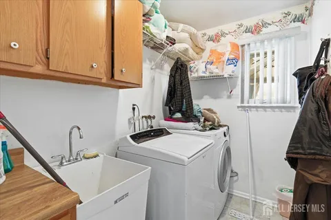 a view of storage and utility room with two washing machine