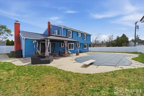 a view of a house with swimming pool and sitting area