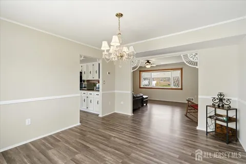 a view of a livingroom with wooden floor and furniture