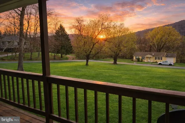 a view of grassy field with benches