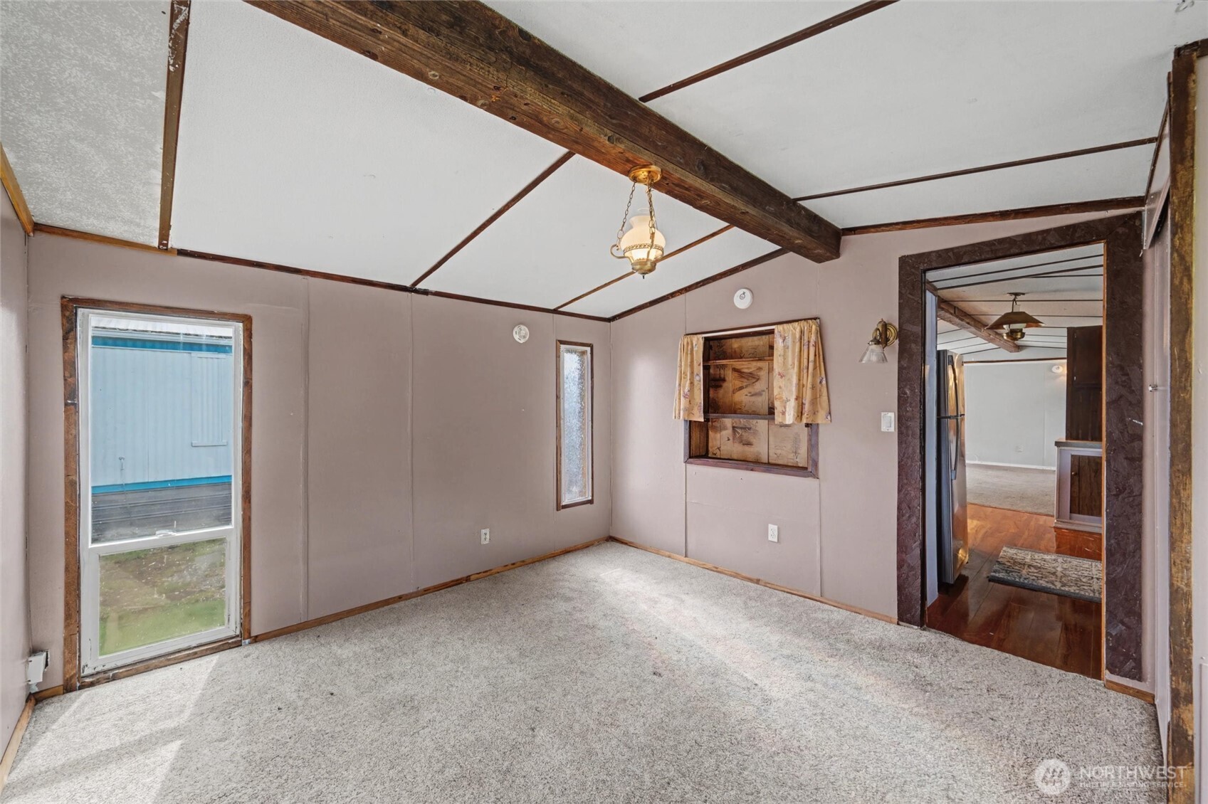 4672 Birch Bay Lynden Road, Unit 157 Blaine, WA 98230 - Photo 13 of 27 a view of a hallway with wooden walls and windows