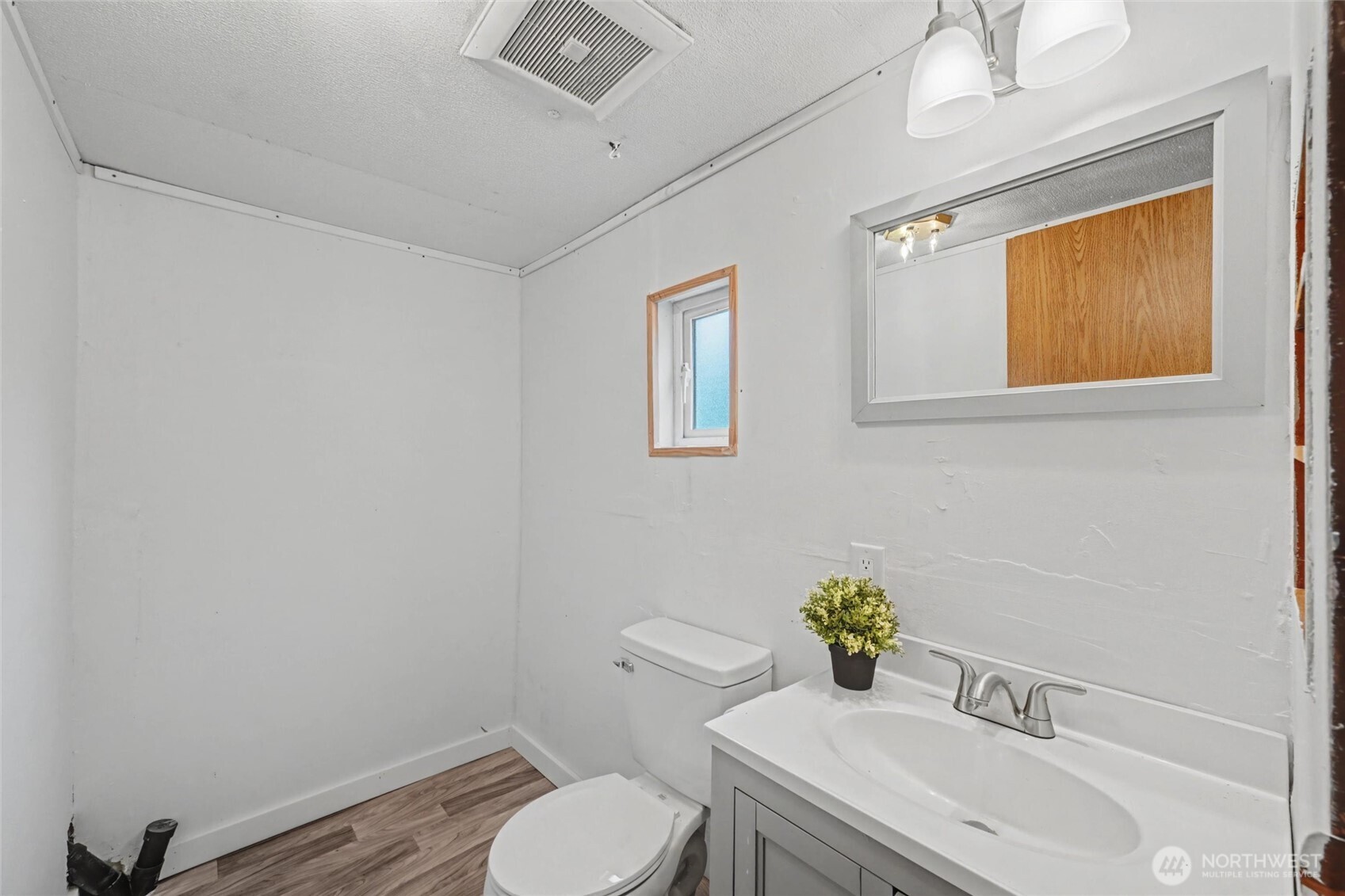 4672 Birch Bay Lynden Road, Unit 157 Blaine, WA 98230 - Photo 23 of 27 a bathroom with a sink a toilet and mirror