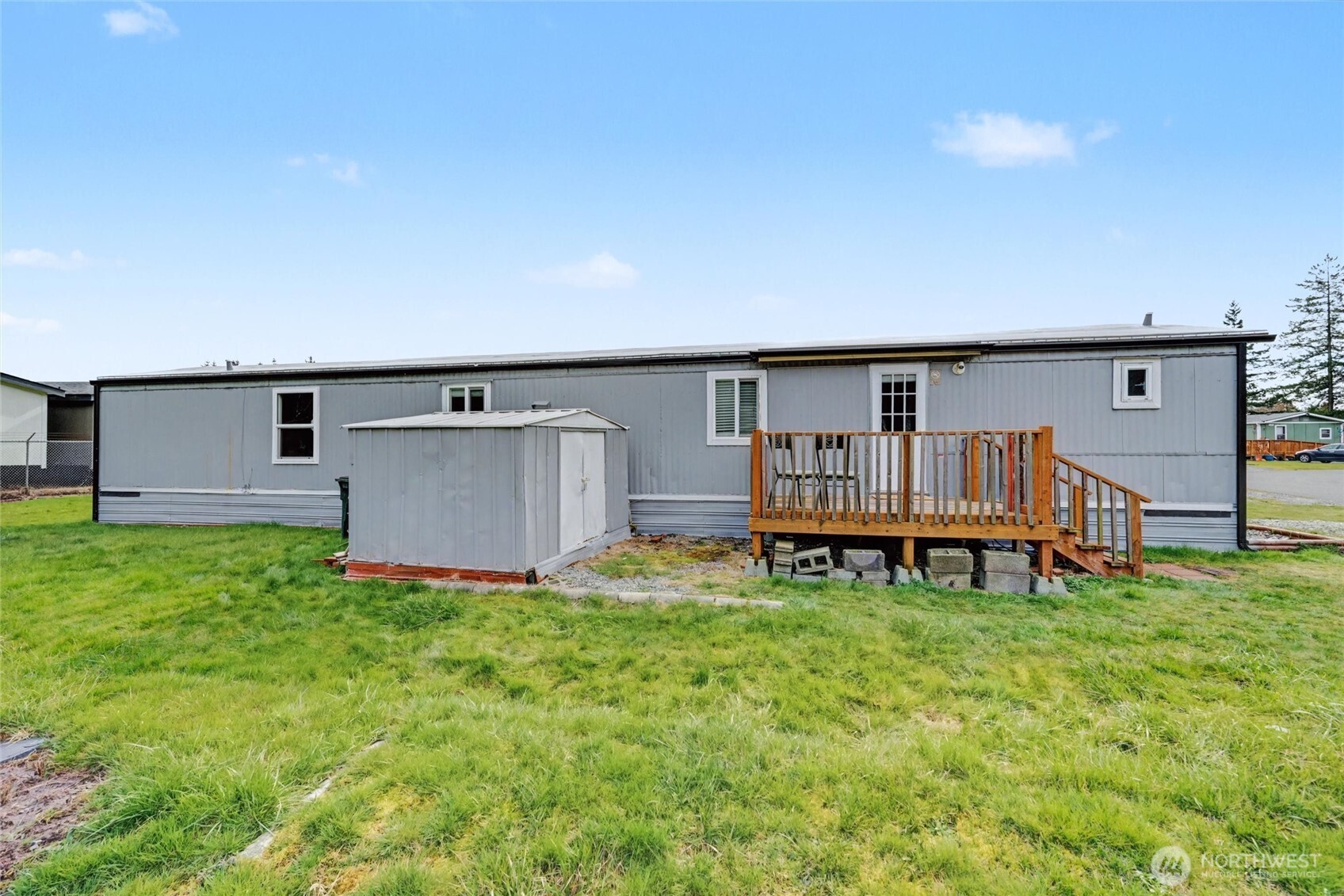 4672 Birch Bay Lynden Road, Unit 157 Blaine, WA 98230 - Photo 26 of 27 a backyard of a house with table and chairs