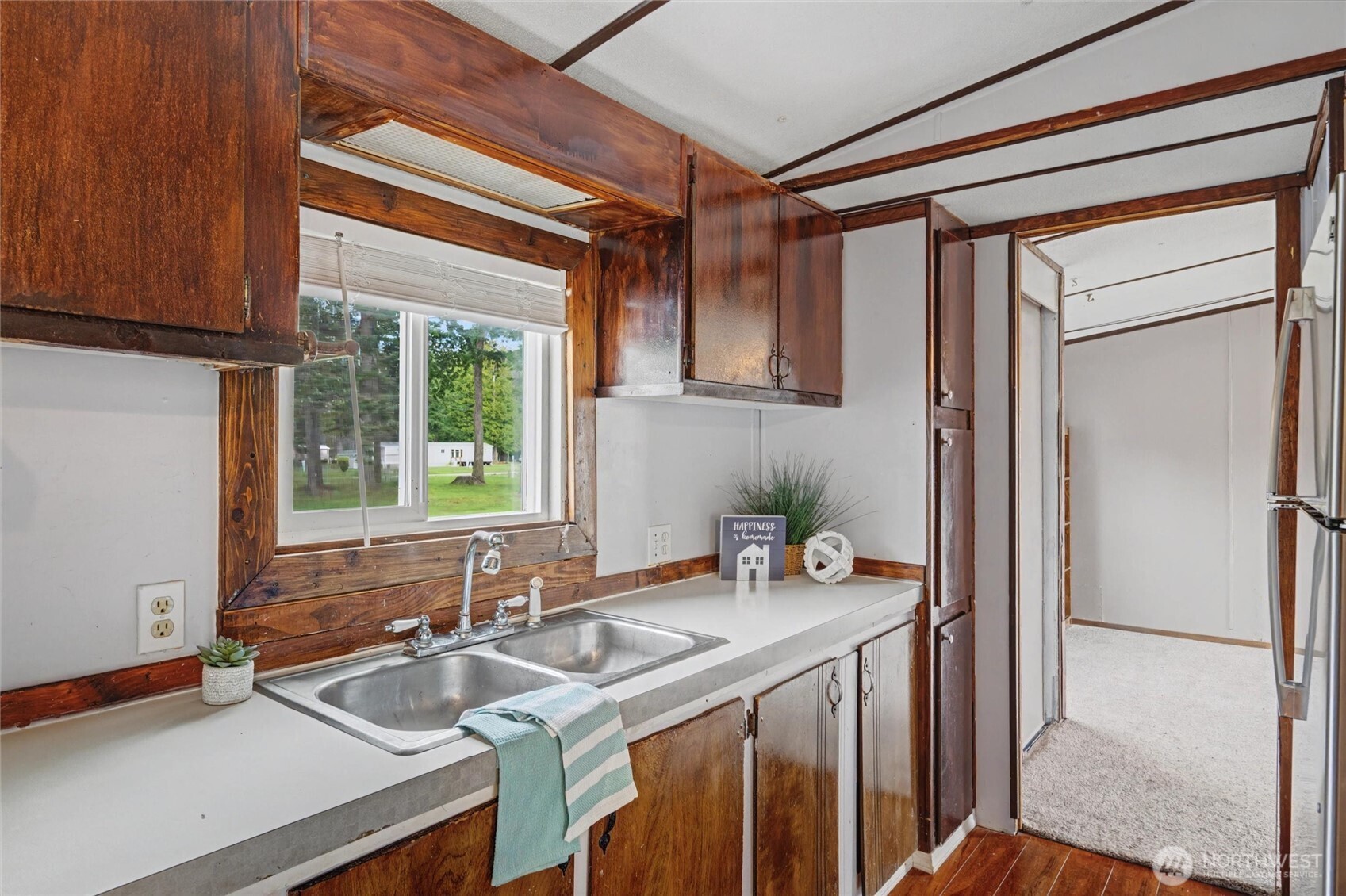 4672 Birch Bay Lynden Road, Unit 157 Blaine, WA 98230 - Photo 10 of 27 a kitchen with a sink refrigerator and cabinets