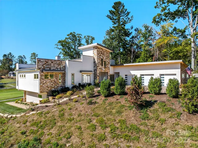 a view of a house with yard and sitting area