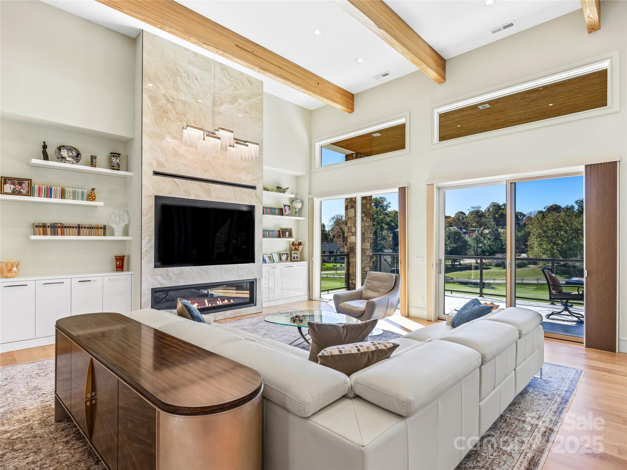 123 Wembley Road Asheville, NC 28804 - Photo 12 of 42 a living room with furniture a flat screen tv and a large window