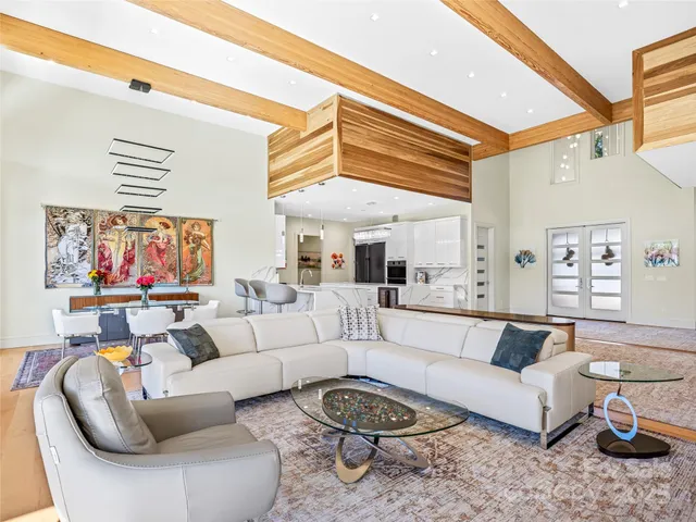 a living room with furniture a rug and a window