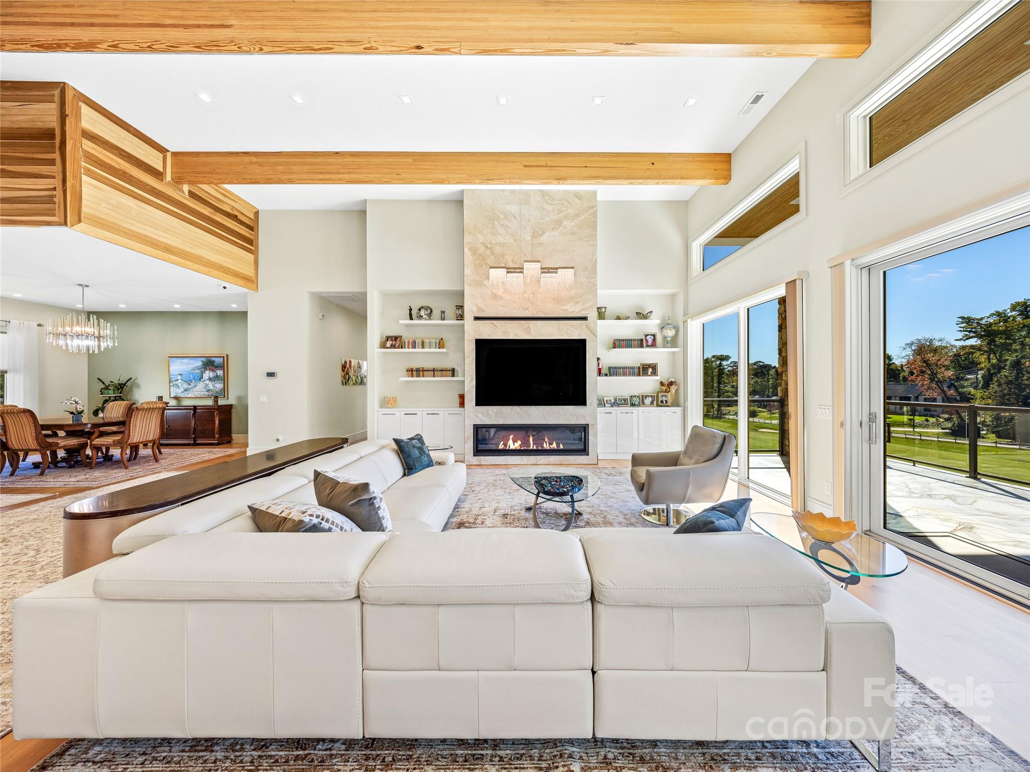 123 Wembley Road Asheville, NC 28804 - Photo 14 of 42 a living room with a large window and a flat screen tv
