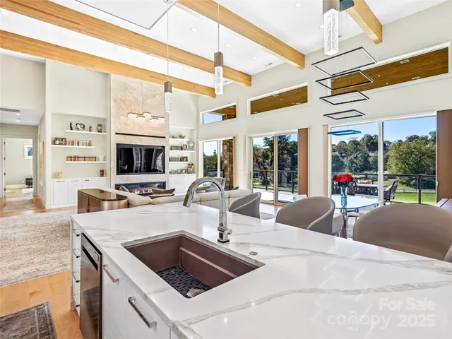 a view of a kitchen with kitchen island a sink and a large window