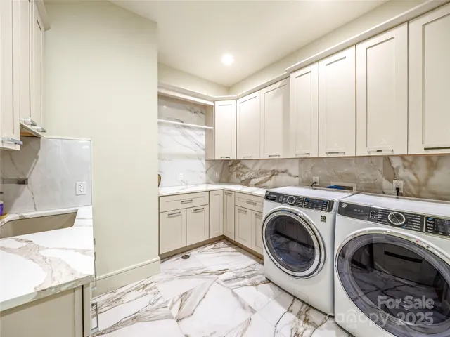 a utility room with sink dryer and washer