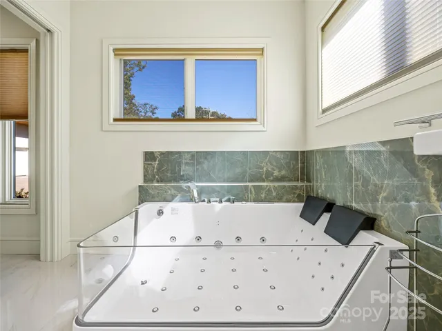 a bathroom with a bathtub and a shower