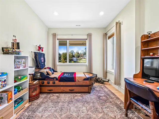 a living room with baby toys and a book shelf