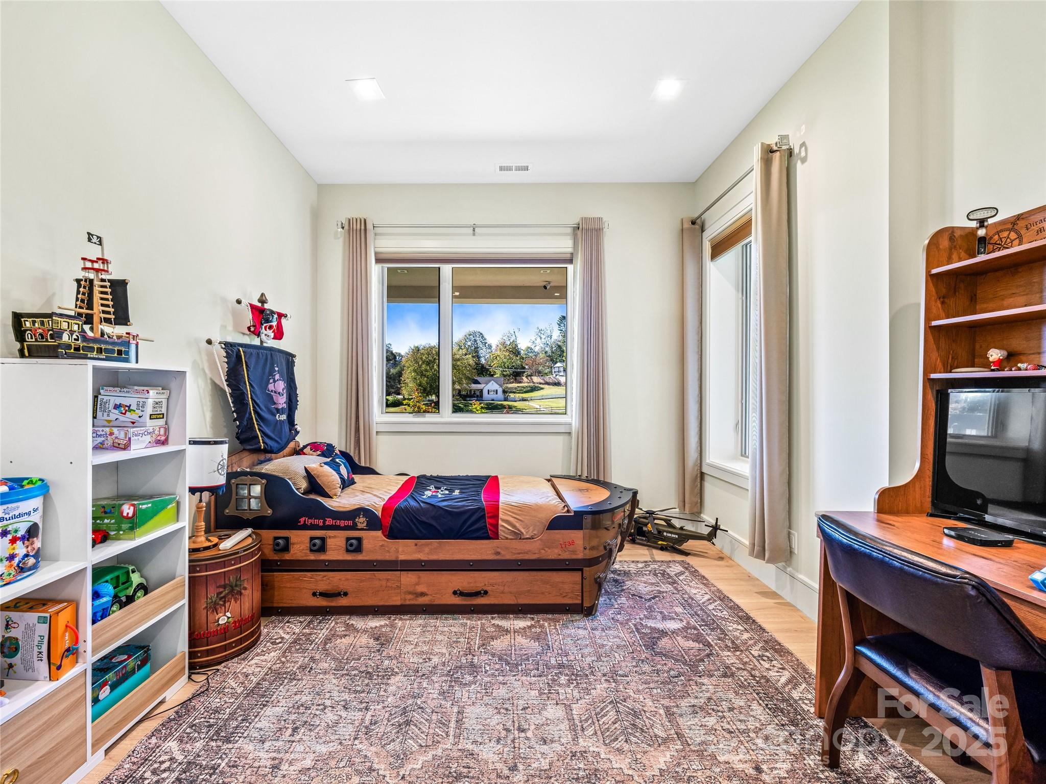 123 Wembley Road Asheville, NC 28804 - Photo 35 of 42 a living room with baby toys and a book shelf