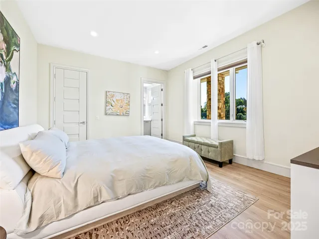 a bedroom with a bed couch and a window