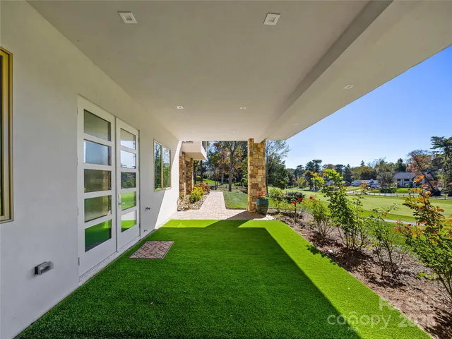 a view of a backyard with plants and a garden