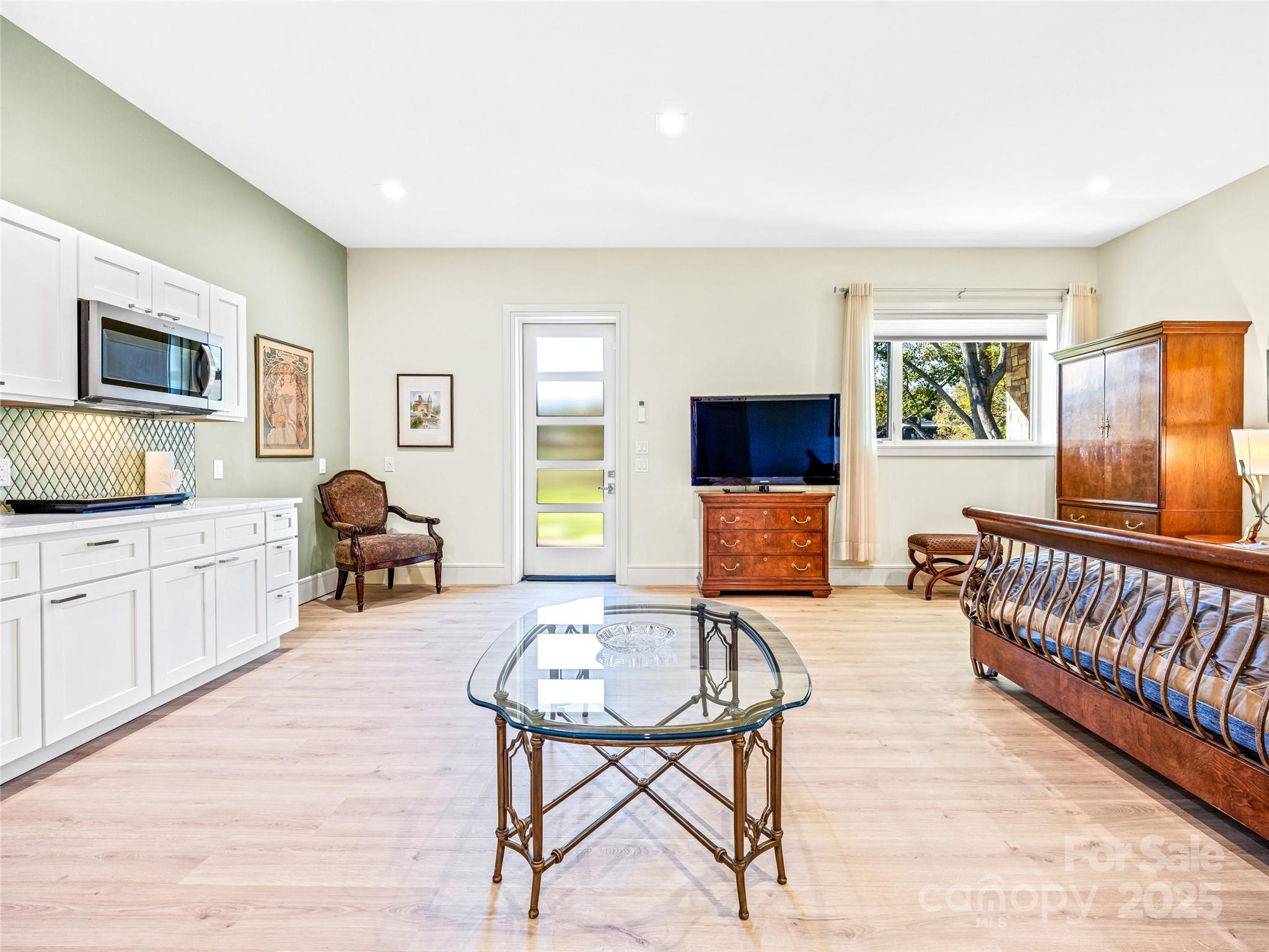 123 Wembley Road Asheville, NC 28804 - Photo 40 of 42 a living room with furniture and a flat screen tv