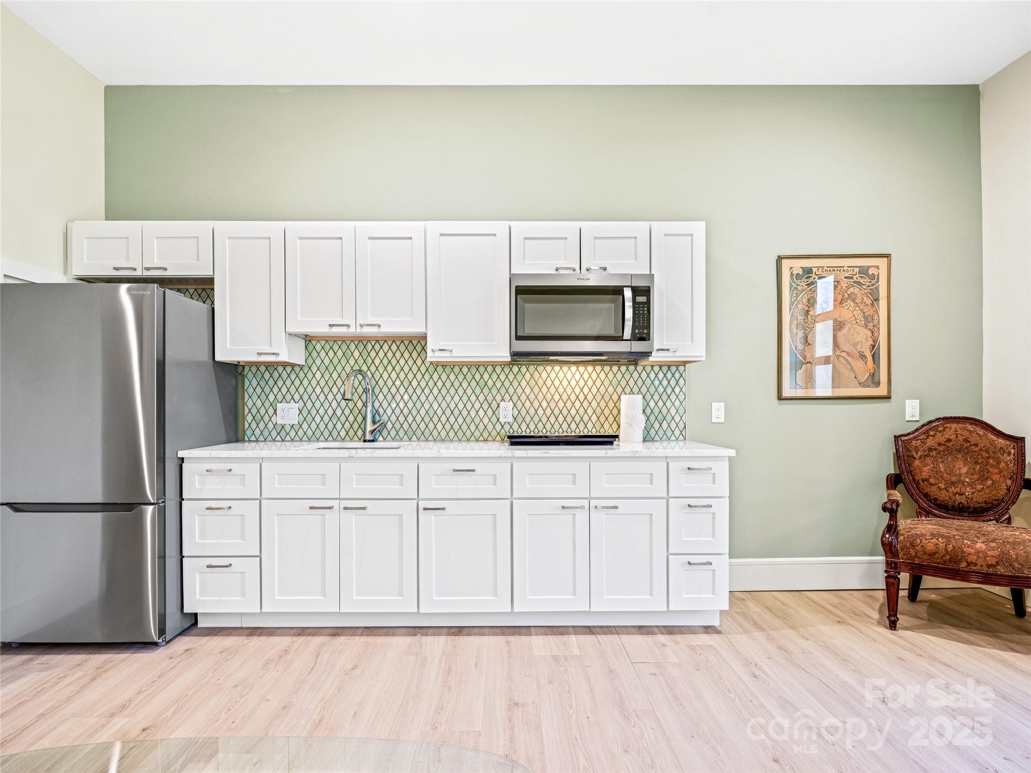 123 Wembley Road Asheville, NC 28804 - Photo 41 of 42 a kitchen with a refrigerator a stove a dining table and chairs