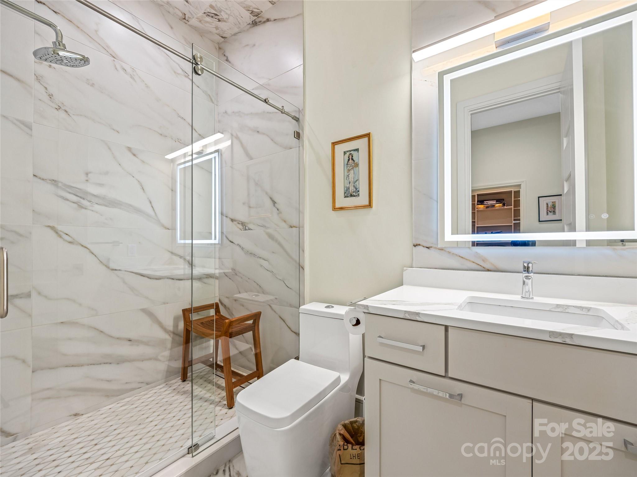 123 Wembley Road Asheville, NC 28804 - Photo 42 of 42 a bathroom with a sink toilet a mirror and shower