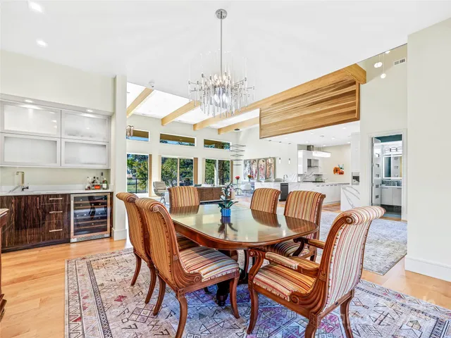 a dining room with furniture a chandelier and wooden floor