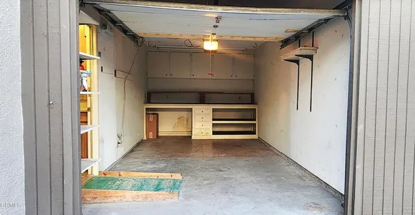 a view of staircase with lots of frames on wall