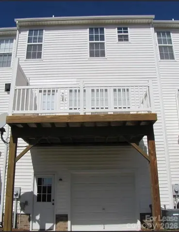 a balcony with a table and chairs