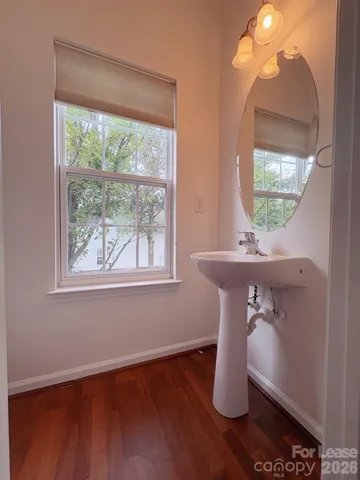 a room with wooden floor and a window