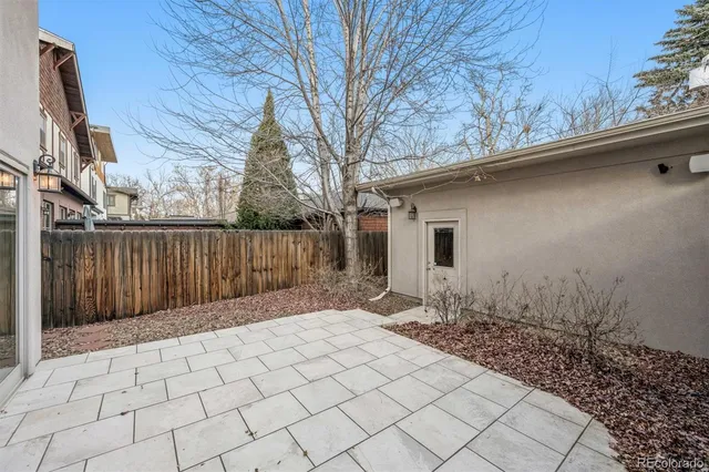 a view of a patio with couches table and chairs and potted plants