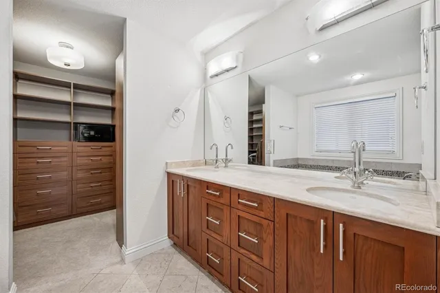 a white bath tub sitting in a bathroom next to a window