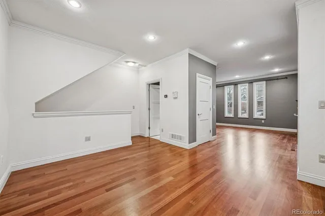 a kitchen with stainless steel appliances granite countertop a sink a stove and a wooden floors