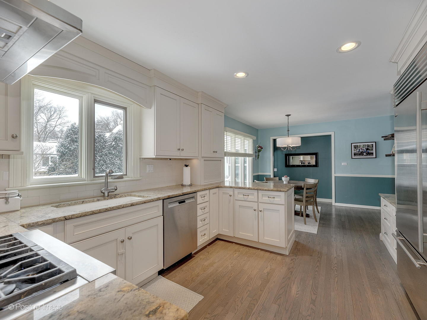 520 County Line Court Hinsdale, IL 60521 - Photo 11 of 33 a large white kitchen with sink and dishwasher a stove top oven with wooden floor