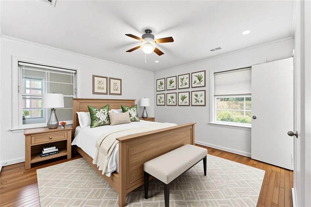 1431 Sharon Street Northwest Atlanta, GA 30314 - Photo 18 of 44 a bedroom with a large bed and a chandelier