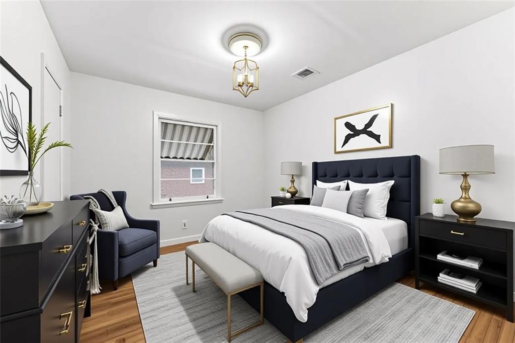 1431 Sharon Street Northwest Atlanta, GA 30314 - Photo 23 of 44 a bedroom with a bed and a chandelier