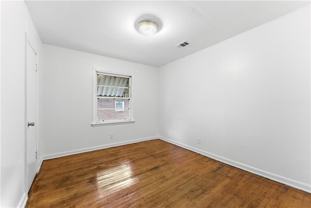 1431 Sharon Street Northwest Atlanta, GA 30314 - Photo 30 of 44 a view of a room with wooden floor and windows