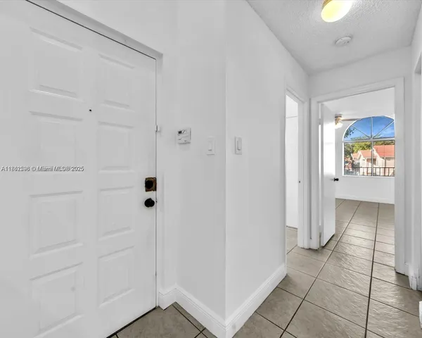 a bathroom with a granite countertop toilet sink and mirror