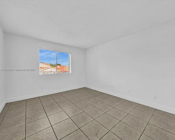 a view of a refrigerator and window in a room