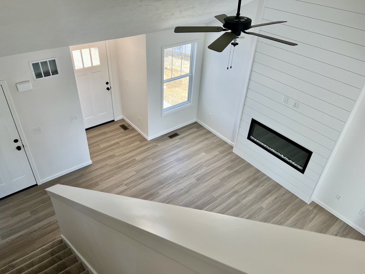 14 Eric Court Bloomington, IL 61705 - Photo 14 of 22 a view of a livingroom with wooden floor and staircase