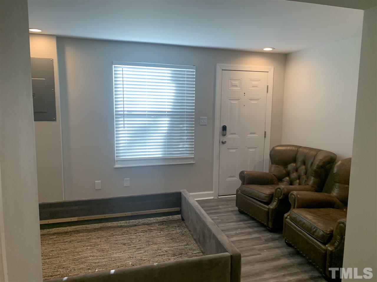 7731 Kelley Court Raleigh, NC 27615 - Photo 13 of 14 a living room with furniture and a rug