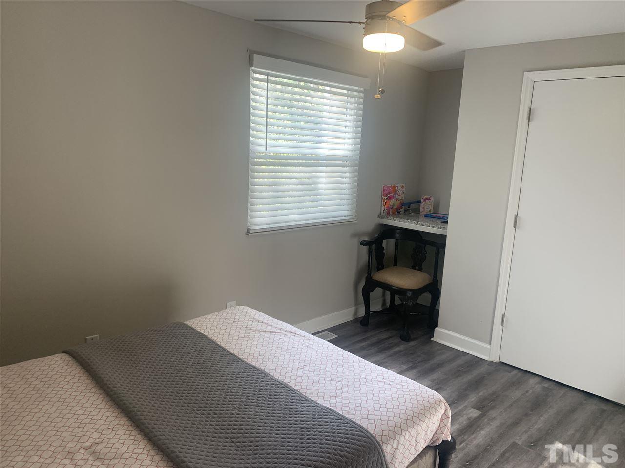 7731 Kelley Court Raleigh, NC 27615 - Photo 5 of 14 a bedroom with a bed and a window