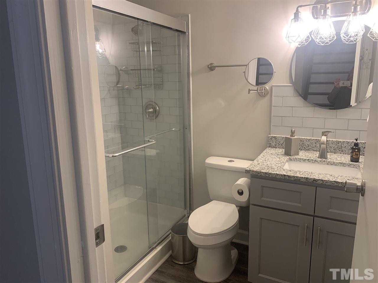 7731 Kelley Court Raleigh, NC 27615 - Photo 8 of 14 a bathroom with a granite countertop sink toilet and shower