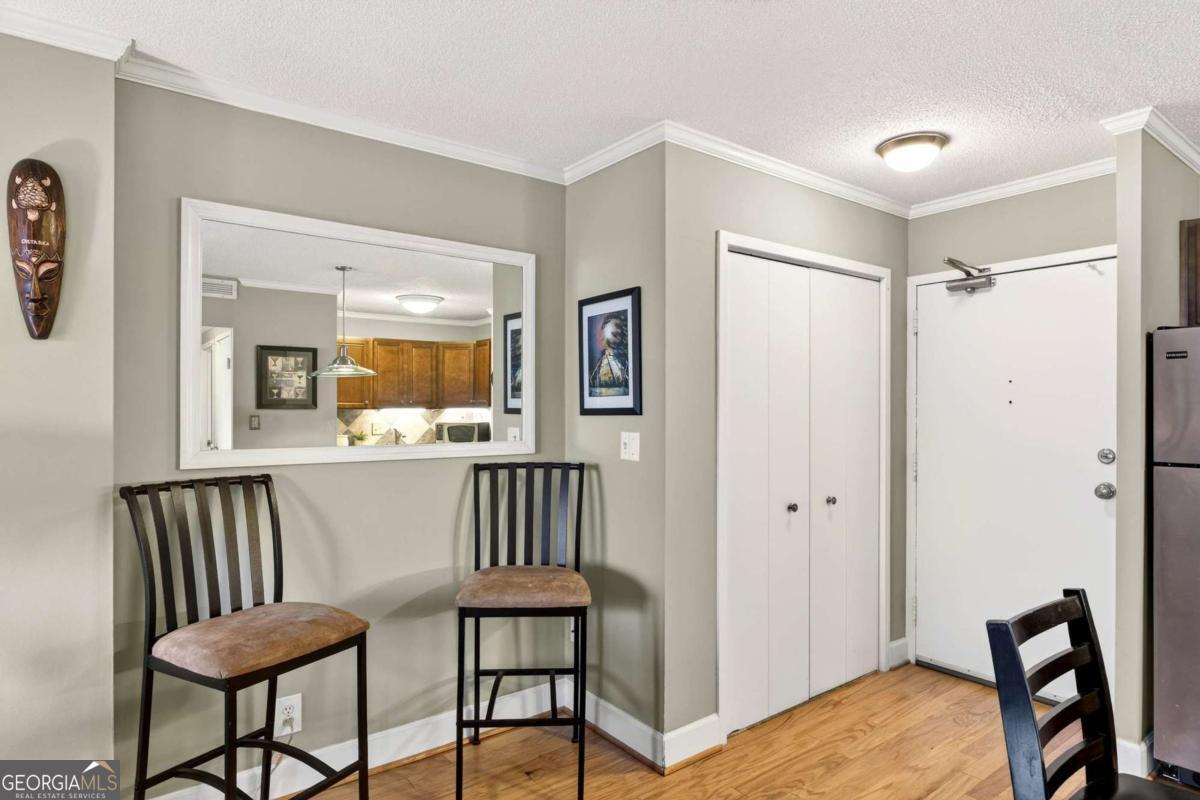 2285 Peachtree Road, Unit 1106 Atlanta, GA 30309 - Photo 11 of 27 a view of a hallway with dining room and furniture