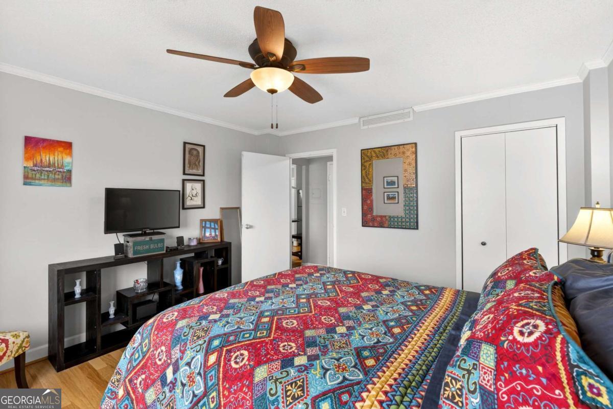 2285 Peachtree Road, Unit 1106 Atlanta, GA 30309 - Photo 13 of 27 a bedroom with a bed and a flat screen tv