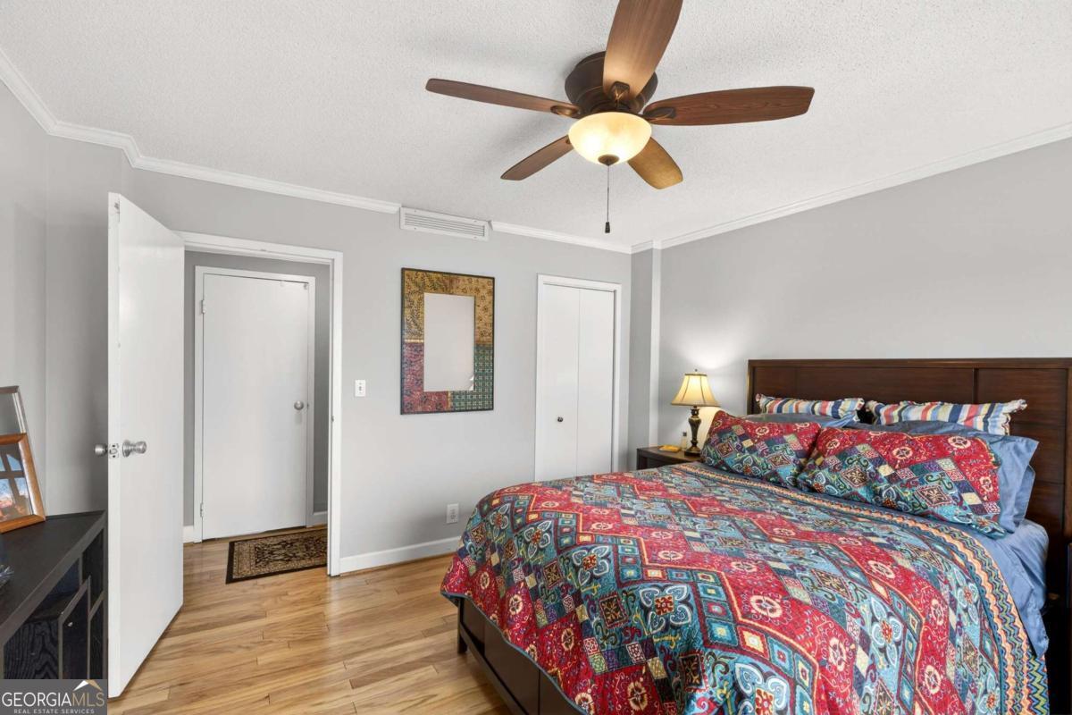 2285 Peachtree Road, Unit 1106 Atlanta, GA 30309 - Photo 14 of 27 a bedroom with a bed and a chandelier