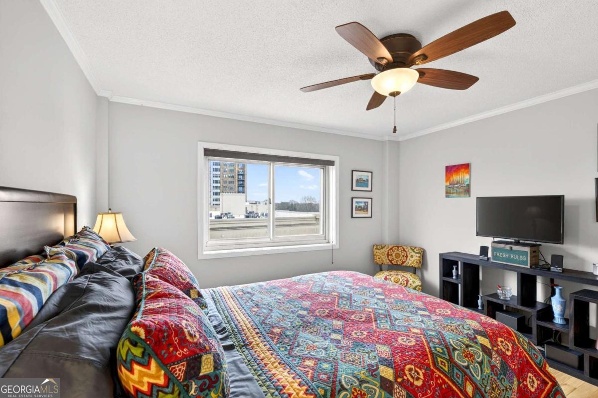 2285 Peachtree Road, Unit 1106 Atlanta, GA 30309 - Photo 15 of 27 a bedroom with a bed and a flat screen tv
