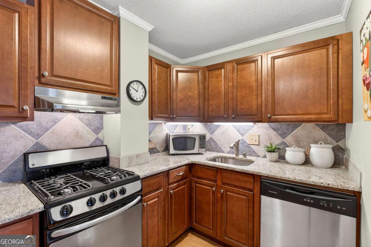 2285 Peachtree Road, Unit 1106 Atlanta, GA 30309 - Photo 4 of 27 a kitchen with a stove and a refrigerator
