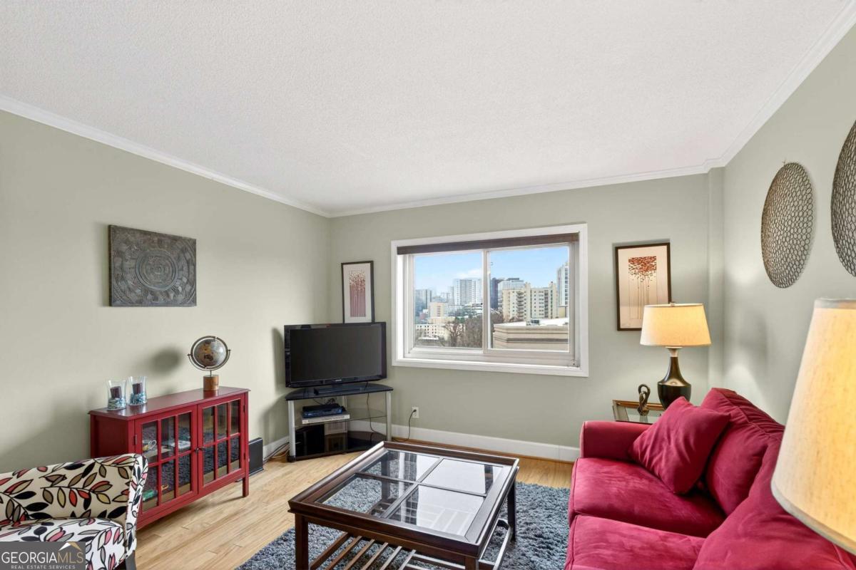 2285 Peachtree Road, Unit 1106 Atlanta, GA 30309 - Photo 6 of 27 a living room with furniture a flat screen tv and a window